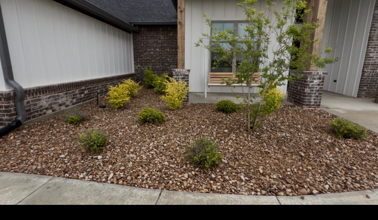 New planting landscape installation with gravel mulch