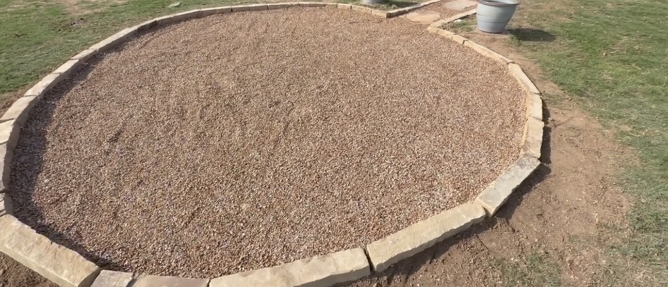 Circular gravel hardscape with stone border edging